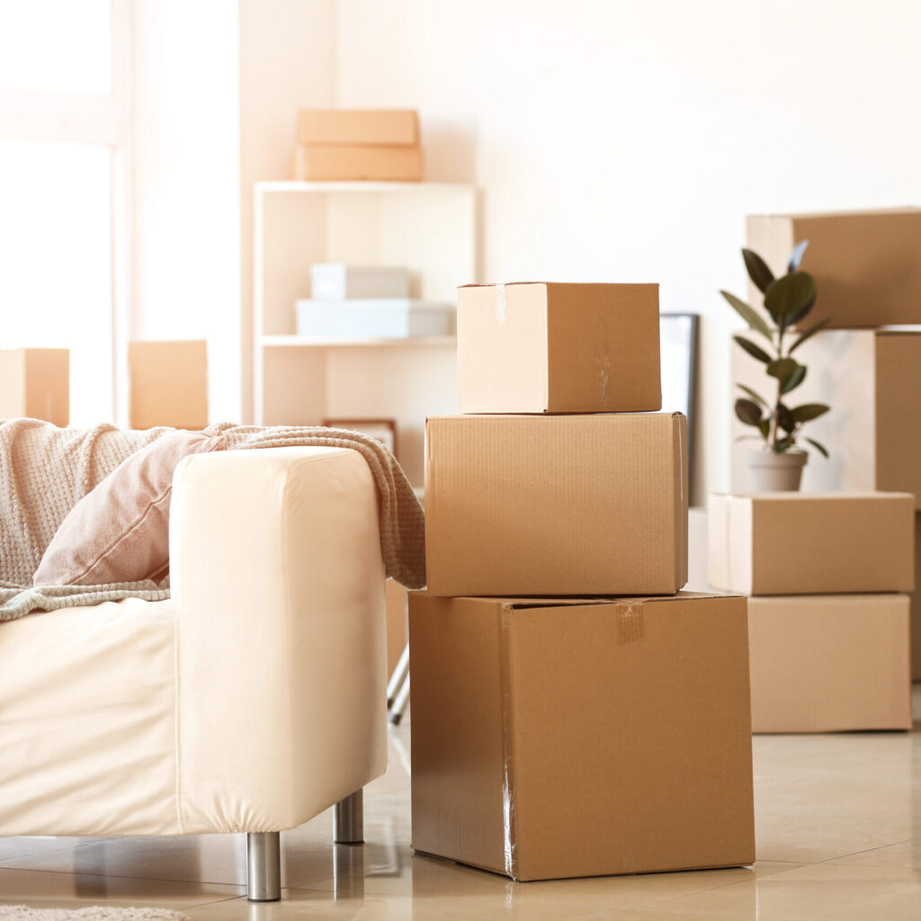 Moving boxes with belongings in room during a packout